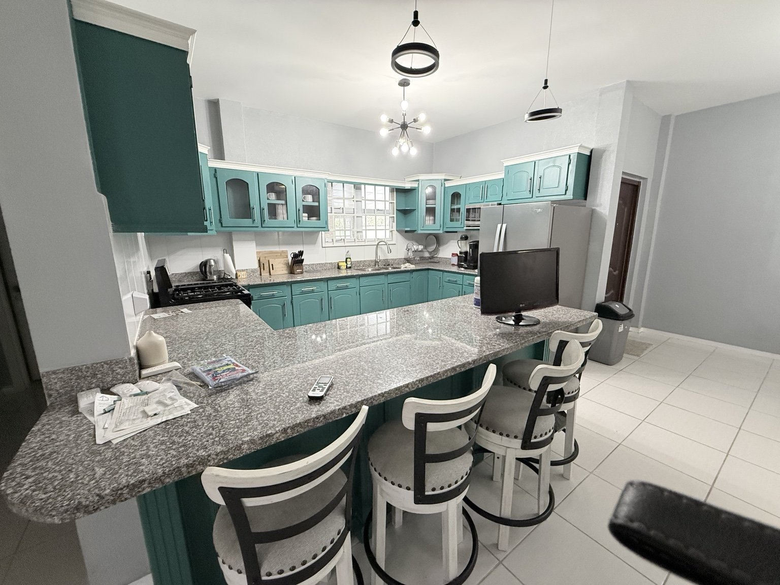 Kitchen with turquoise cabinetry and breakfast counter