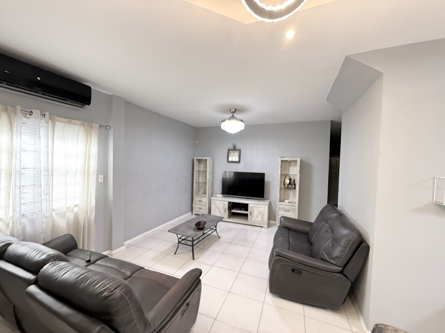 Furnished living room with sofas and television